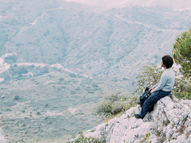 hiker sitting on the rock